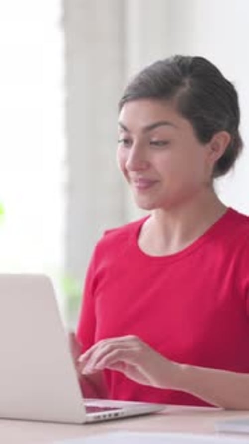 Indian Woman Talking on Video Call on Laptop in Office, Vertical Video