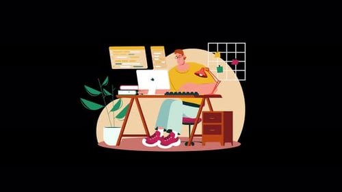 A young European man working at a desk with a laptop.