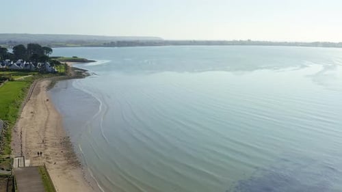 Birds eye view above Waterford sandy beach seaside on sunny day