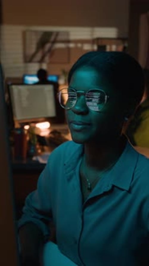 Vertical of Black Female Developer Coding with Code Reflection in Glasses