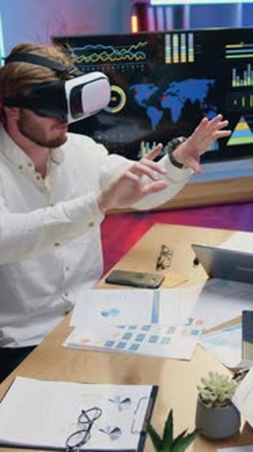 Man Uses VR Headset at Office Desk