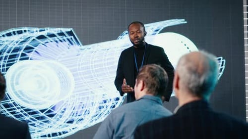 Speaker Presents to Audience About a Blue Print