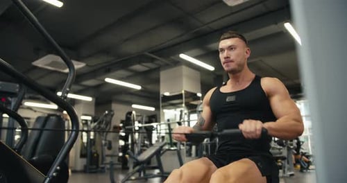 Slow Motion Young Athlete Performs Exercises with Weights to Strengthen the Muscles of the Back and