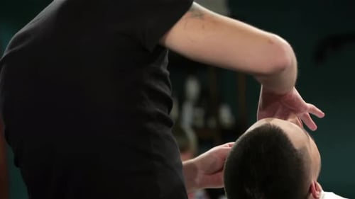Handsome Man Getting His Beard Shaved in a Barber Shop