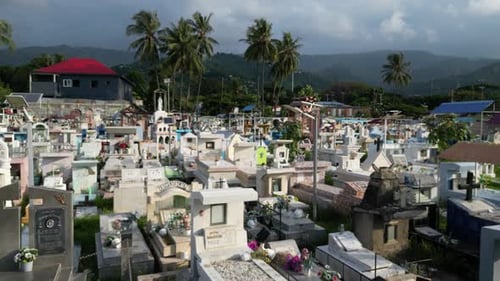Drone footage of Santa Cruz Cemetery surrounded by mountains and palm trees