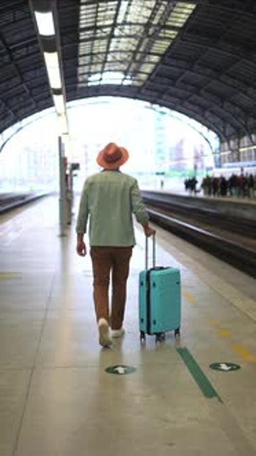 Traveler Walks with Luggage in a Subway Station