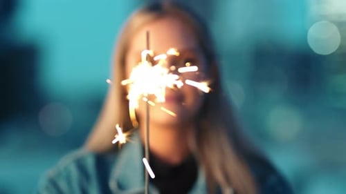 Sparkle, woman and birthday sparkler of a person at birthday, party or holiday event