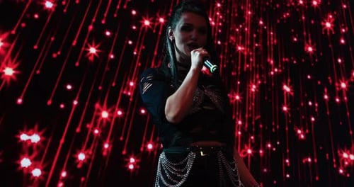 Young Woman Singer Performing on Stage at Night