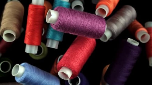 Multicolored Threads Fly on a Black Background Filmed on a Highspeed Camera at 1000 Fps