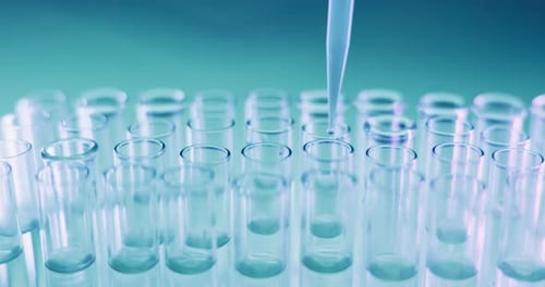 Pipette Drops Liquid into Glass Test Tubes