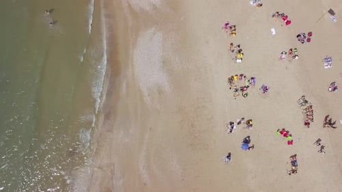 Mediterranean beach during summer with people in the water