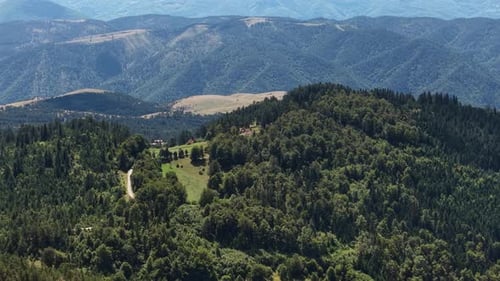 Aerial View of Idyllic Mountain Landscape Scenery in Summer Season, Pine Forest and Hilltop Homes