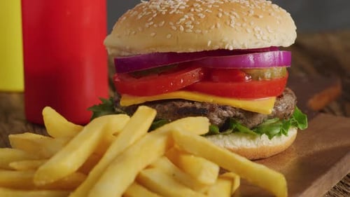 Delicious Burger and French Fries on Wooden Board