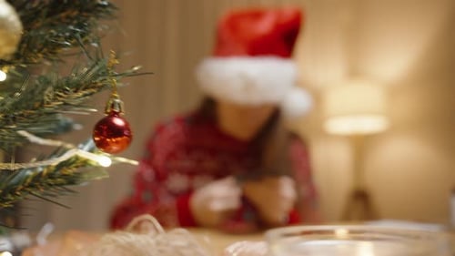 Woman Making Christmas Decorations at Home