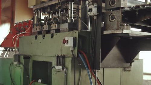 Industrial metal stamping machine operating in a factory
