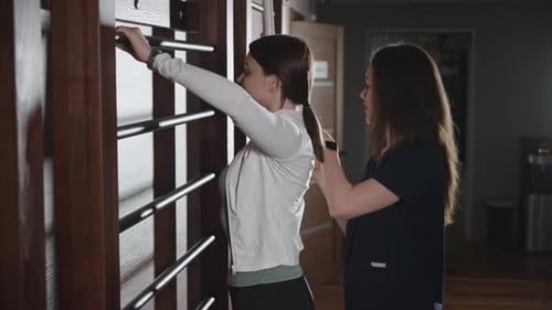 Medical Sports Rehabilitation After Injury and Surgery A Medical Trainer Works with a Patient Under