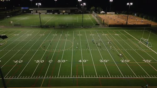 Aerial View Women Soccer Players Playing Soccer at the Stadium at Night