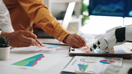 Business Team with Robot Analyzing Data Charts Together