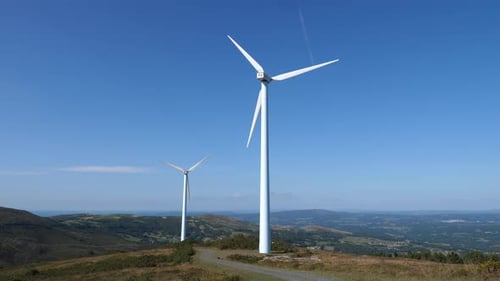 Wind Turbines Spinning on Rolling Green Hills