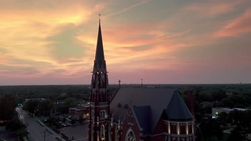 A Large Catholic Church in the Suburbs at Sunset Aerial Wide Shot