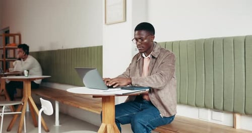 Business, man and typing on laptop at cafe for research, editing article and newsletter report