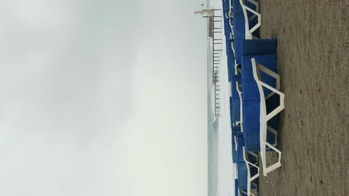 Empty sunbeds on sandy beach. Vertical video