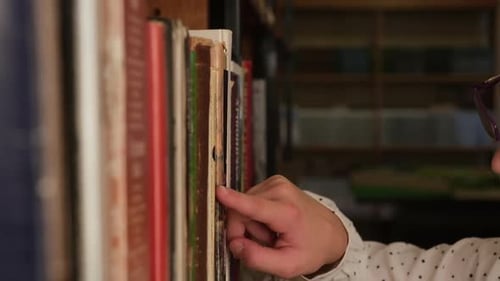 Kid Selecting Books on Bookshelf in Old Library Close Up School Education