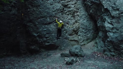 Footage of Young Slim Sportsman Wearing Helmet Climbing on Stone Rock Wall Mountain Climb Amateur