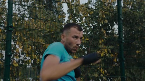 Man Boxer Punches Air Outside