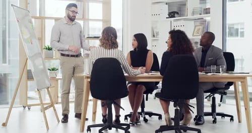 4k video footage of a young businessman giving a presentation to his colleagues in an office