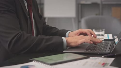 Professional Types on Laptop in Office Workplace