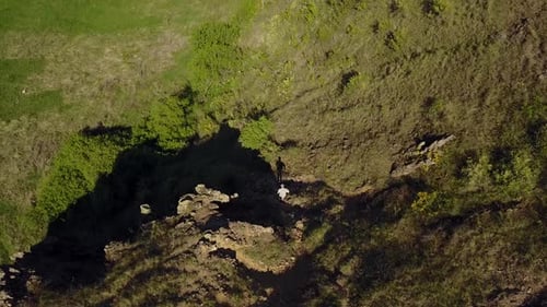 Aerial View of Man Coming Down the Mountain Male Hiking Down the Rocky Cliff Alone Climber in the