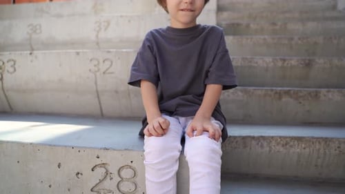 Smiling Boy with Green Hair Sitting on Steps