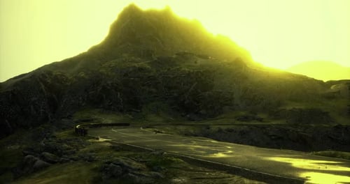 Breathtaking Mountainous Landscape at Sunset with Winding Road and Mist