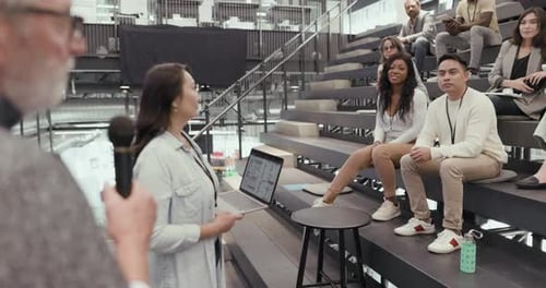 Presentation with diverse group of adults in stadium seating