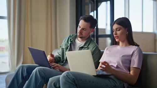 Working Couple Discussing Laptop Screen Talking Couch Closeup Man Asking Wife