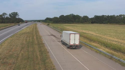 Aerial Shot of Truck with Cargo Trailer Driving on Road and Transporting Goods Flying Over Delivery