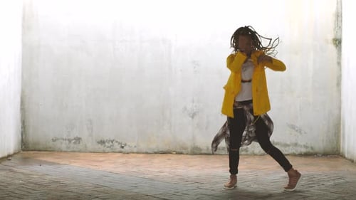 Energetic Young Adult Dancing in Urban Setting