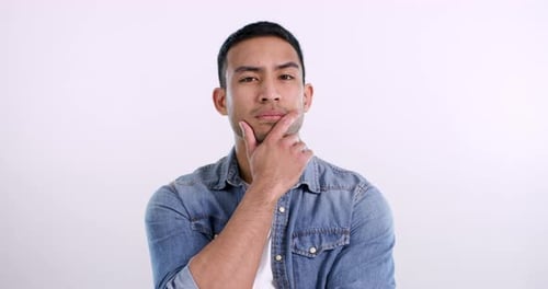 Man, face and thinking or hand in studio for problem solving, solution or pink background