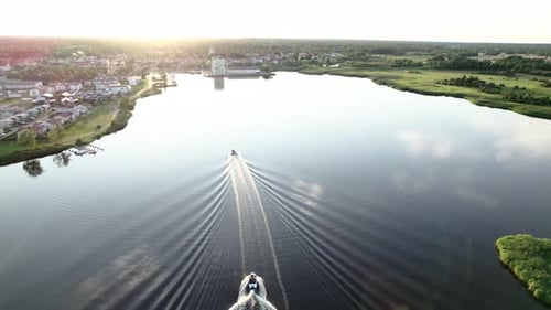 Following 2 boats heading to land in small town