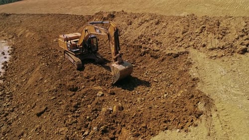 Excavator Digging in Construction Site Aerial Shot