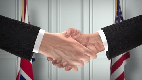 International Business Handshake with UK and USA Flags