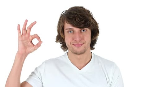 Young Adult Gives Okay Sign on White Background