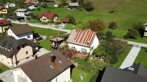 Wide orbit shot of Roofing repair at settlement complex. drone aerial view.