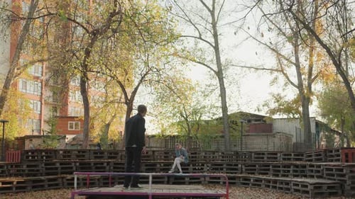 Man Directing a Woman in an Autumn Park