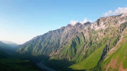 Aerial View of Green Caucasus Mountains Majestic Peaks with Lush Vegetation and Clear Sky Remote