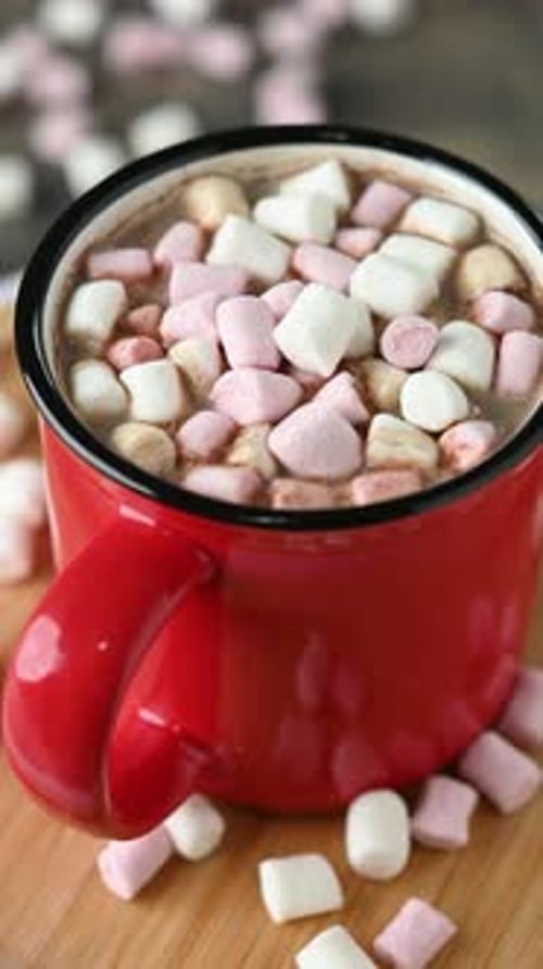 Hot chocolate drink with marshmallows in red mug