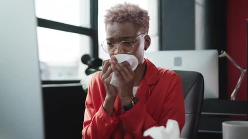Woman in Office Sick with Cold or Allergies