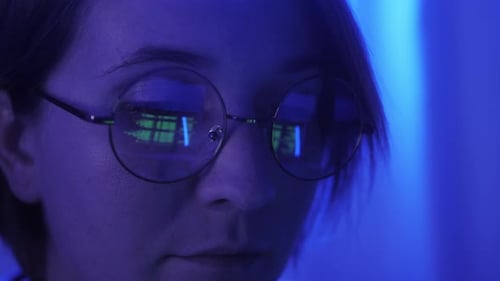 Woman Wearing Glasses with Code Reflection
