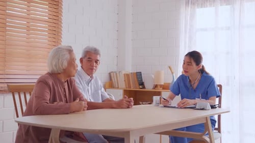 Senior Couple Meeting with Healthcare Professional at Home